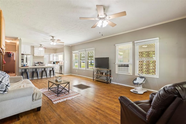 724 Maple St, Perry, OK 73077 - living room featuring baseboards, a ceiling fan, and wood finished floors