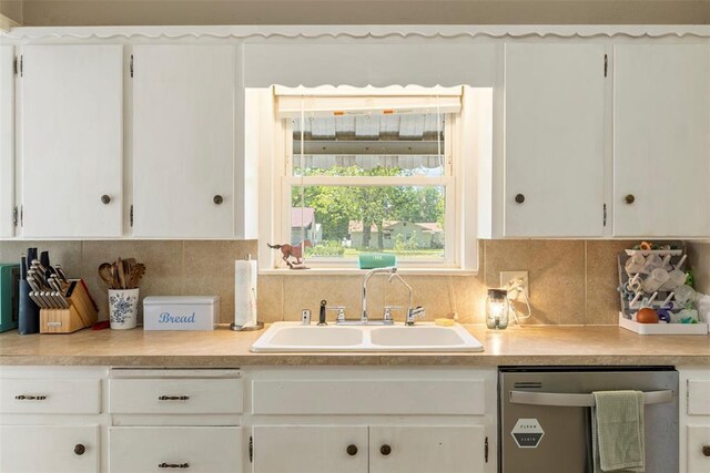 724 Maple St, Perry, OK 73077 - kitchen featuring light countertops, white cabinets, a sink, and dishwasher