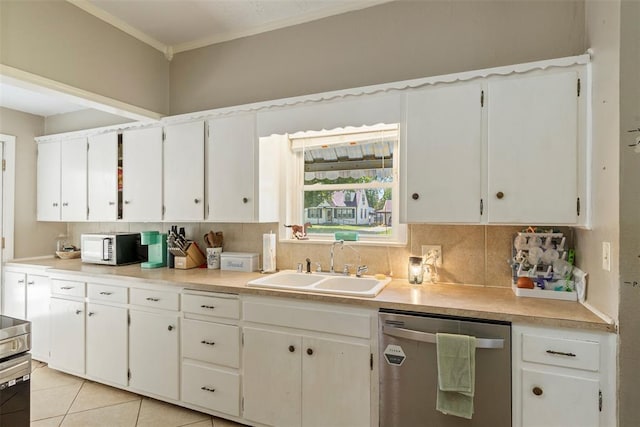 724 Maple St, Perry, OK 73077 - kitchen featuring backsplash, a sink, light countertops, ornamental molding, and stainless steel appliances
