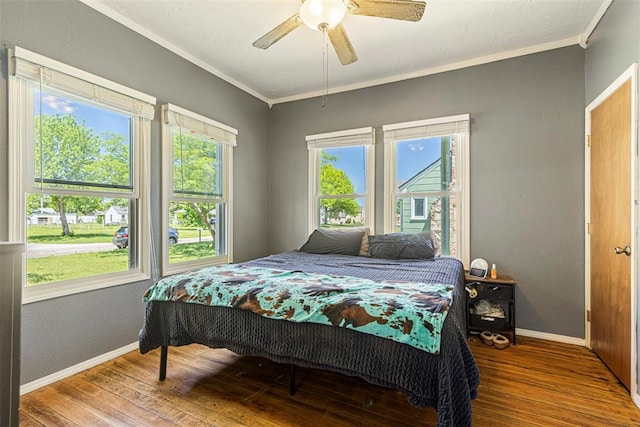 724 Maple St, Perry, OK 73077 - bedroom featuring crown molding, a ceiling fan, baseboards, and hardwood / wood-style flooring
