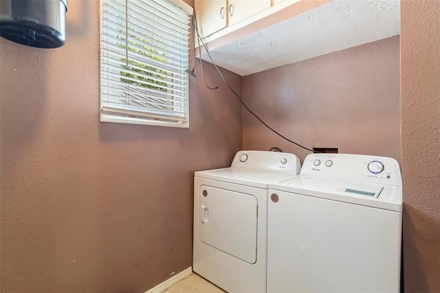 724 Maple St, Perry, OK 73077 - washroom with a textured wall, cabinet space, and washing machine and clothes dryer