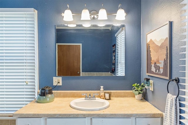 724 Maple St, Perry, OK 73077 - bathroom featuring vanity and a textured wall