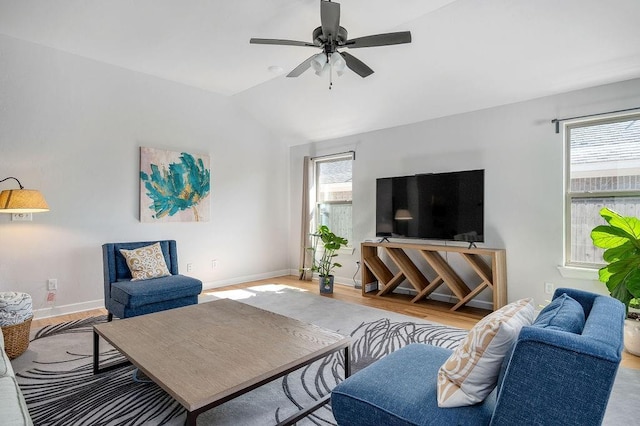 living room with baseboards, vaulted ceiling, wood finished floors, and ceiling fan