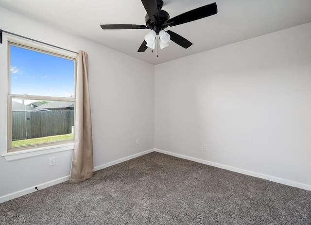 carpeted empty room featuring baseboards and ceiling fan