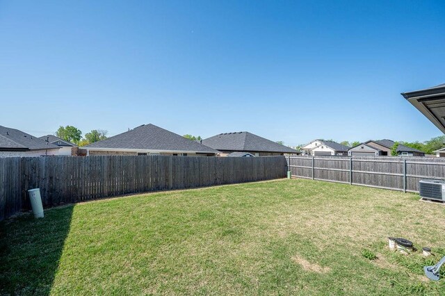 view of yard with a fenced backyard and cooling unit