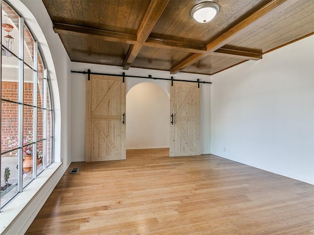 11609 Windmill Rd, Oklahoma City, OK 73162 - empty room featuring a barn door, coffered ceiling, wooden ceiling, light wood-type flooring, and beam ceiling