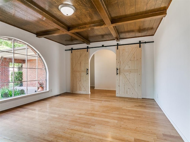 11609 Windmill Rd, Oklahoma City, OK 73162 - empty room with a barn door, light wood finished floors, wooden ceiling, coffered ceiling, and beam ceiling