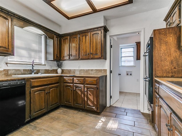 11609 Windmill Rd, Oklahoma City, OK 73162 - kitchen with light wood-style flooring, a sink, and black appliances