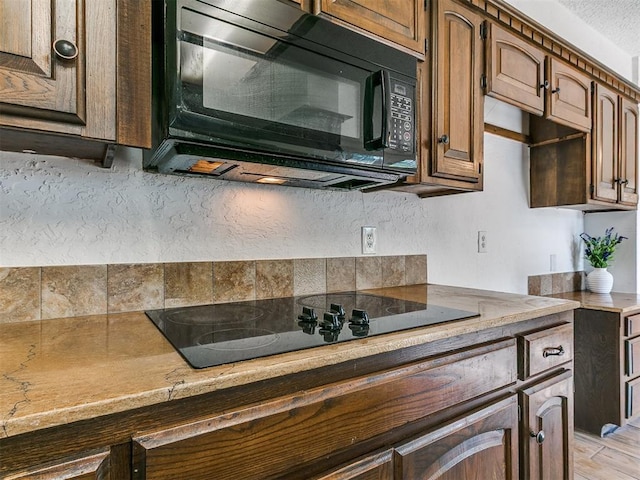 11609 Windmill Rd, Oklahoma City, OK 73162 - kitchen with light countertops, backsplash, and black appliances
