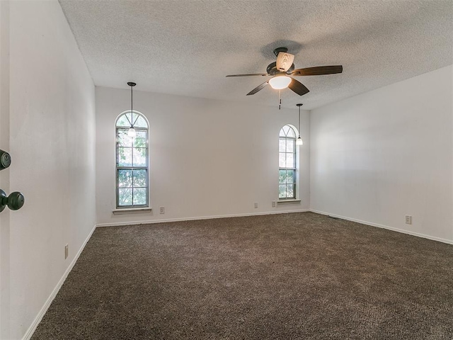11609 Windmill Rd, Oklahoma City, OK 73162 - spare room featuring dark carpet, a textured ceiling, a ceiling fan, and baseboards