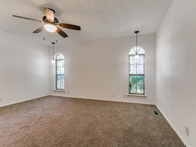 11609 Windmill Rd, Oklahoma City, OK 73162 - carpeted empty room featuring baseboards, a ceiling fan, a textured ceiling, and visible vents