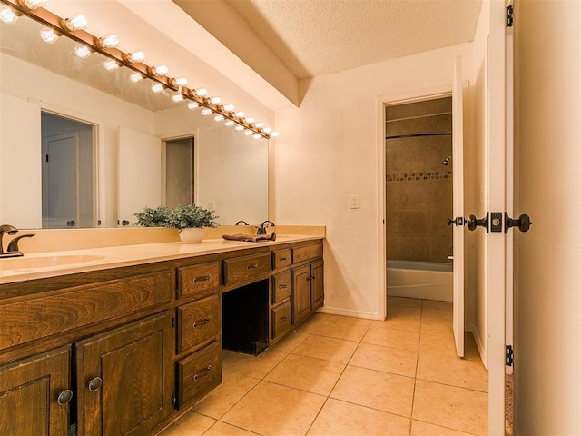 11609 Windmill Rd, Oklahoma City, OK 73162 - full bath featuring tile patterned floors, double vanity, a sink, baseboards, and a textured ceiling