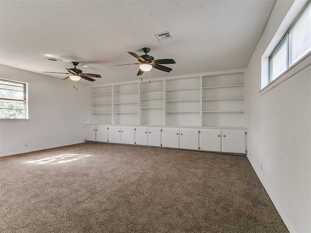 11609 Windmill Rd, Oklahoma City, OK 73162 - carpeted empty room featuring visible vents, a wealth of natural light, and a textured ceiling