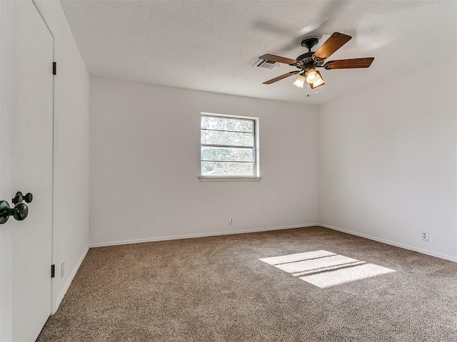 11609 Windmill Rd, Oklahoma City, OK 73162 - empty room with carpet flooring, a textured ceiling, visible vents, baseboards, and a ceiling fan