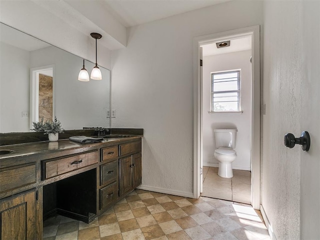 11609 Windmill Rd, Oklahoma City, OK 73162 - full bath with baseboards, a sink, double vanity, and toilet