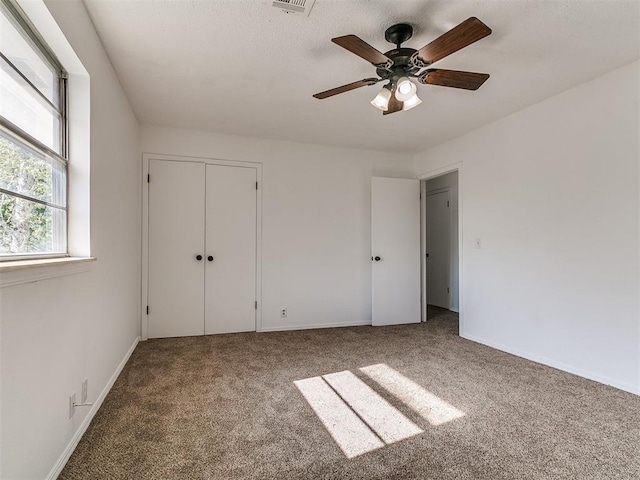 11609 Windmill Rd, Oklahoma City, OK 73162 - unfurnished bedroom featuring carpet, a closet, a ceiling fan, and baseboards