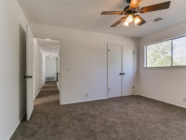 11609 Windmill Rd, Oklahoma City, OK 73162 - unfurnished room with visible vents, dark carpet, a textured ceiling, and ceiling fan