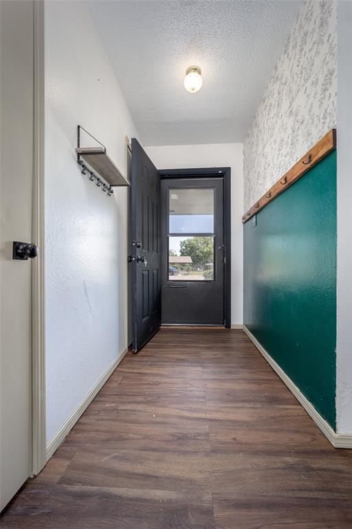 1906 NW 66th Cir, Lawton, OK 73505 - entryway featuring baseboards, a textured ceiling, and wood finished floors