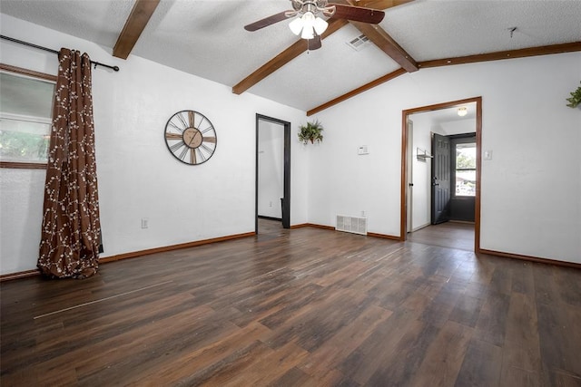 1906 NW 66th Cir, Lawton, OK 73505 - unfurnished living room featuring a ceiling fan, visible vents, lofted ceiling with beams, and wood finished floors