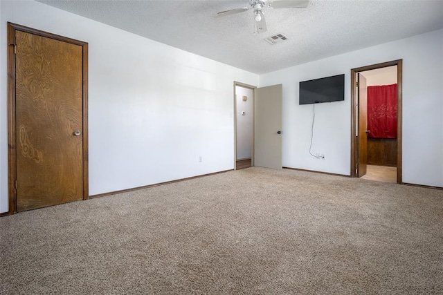 1906 NW 66th Cir, Lawton, OK 73505 - unfurnished bedroom featuring visible vents, baseboards, a textured ceiling, carpet flooring, and ensuite bath