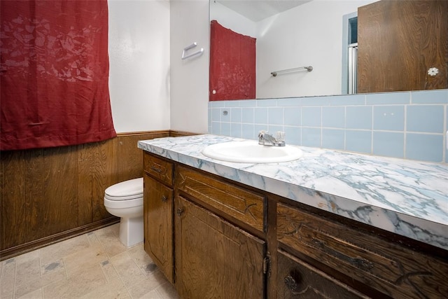 1906 NW 66th Cir, Lawton, OK 73505 - bathroom featuring vanity, a shower with door, wainscoting, and toilet