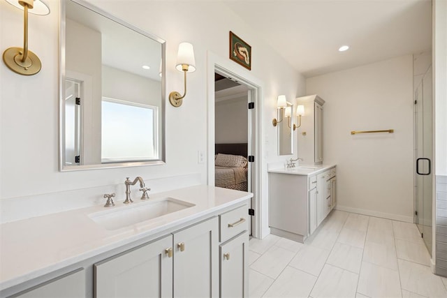 4162 Hawthorne St NW, Piedmont, OK 73078 - bathroom featuring two vanities, connected bathroom, a stall shower, and recessed lighting