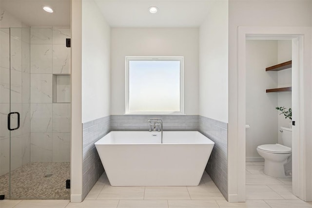 4162 Hawthorne St NW, Piedmont, OK 73078 - full bathroom featuring a freestanding bath, a marble finish shower, recessed lighting, and tile walls