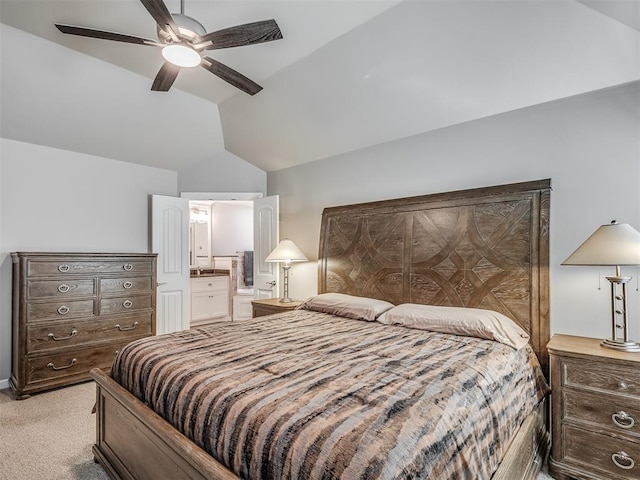 bedroom with ceiling fan, vaulted ceiling, ensuite bathroom, and light carpet