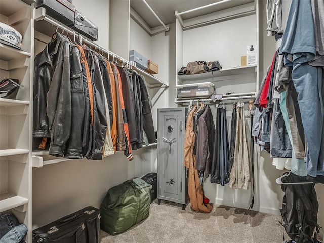 walk in closet featuring carpet flooring