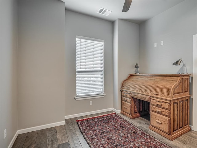 office with baseboards, a healthy amount of sunlight, and wood finished floors