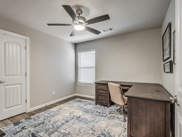 home office featuring ceiling fan, baseboards, visible vents, and light wood-type flooring