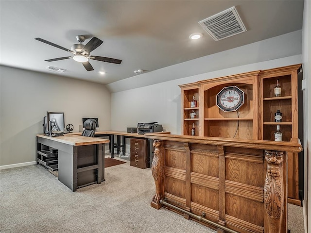 office featuring light carpet, a ceiling fan, and visible vents
