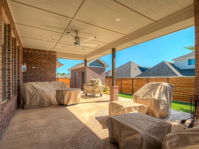 view of patio with ceiling fan, a fenced backyard, and a grill
