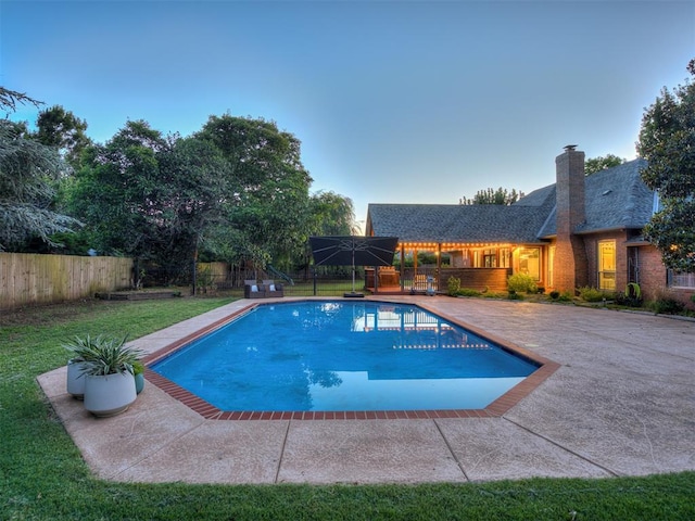 4216 Two Lakes Ave, Norman, OK 73072 - pool at dusk with a fenced backyard and a patio