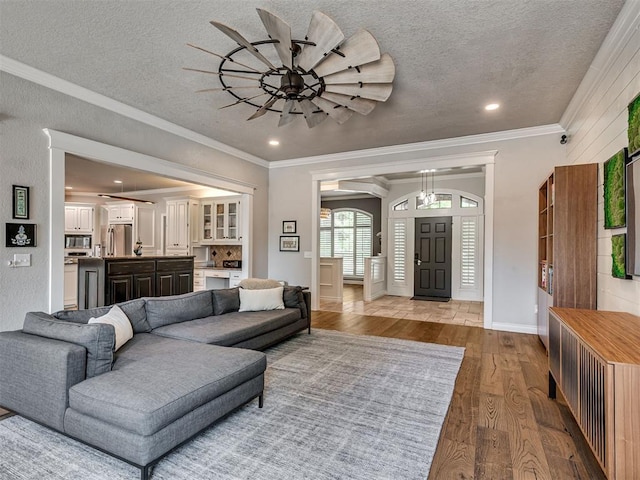 4216 Two Lakes Ave, Norman, OK 73072 - living area with wood finished floors, crown molding, recessed lighting, a textured ceiling, and a ceiling fan