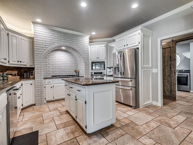 4216 Two Lakes Ave, Norman, OK 73072 - kitchen with appliances with stainless steel finishes, decorative backsplash, a kitchen island, crown molding, and dark stone countertops