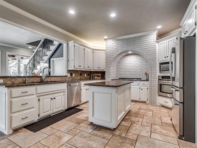 4216 Two Lakes Ave, Norman, OK 73072 - kitchen featuring stainless steel appliances, stone tile floors, tasteful backsplash, ornamental molding, and recessed lighting