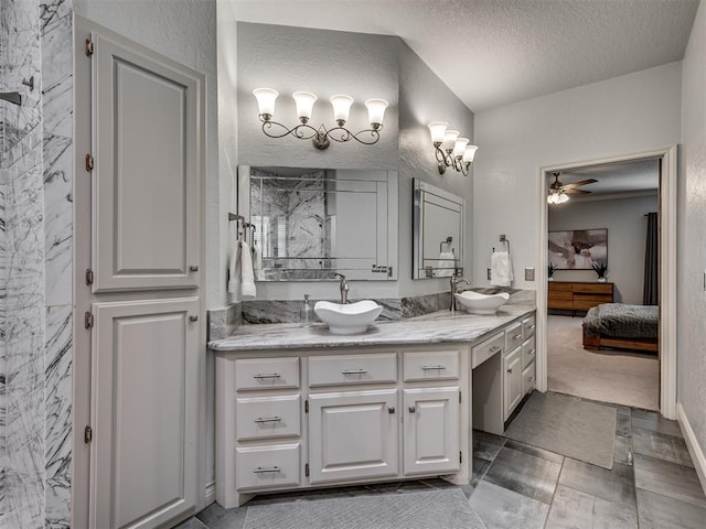 4216 Two Lakes Ave, Norman, OK 73072 - ensuite bathroom with double vanity, ceiling fan, a textured ceiling, a textured wall, and a marble finish shower