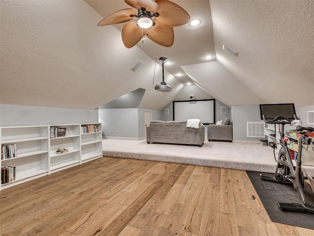 4216 Two Lakes Ave, Norman, OK 73072 - exercise room with a textured ceiling, ceiling fan, wood finished floors, vaulted ceiling, and built in shelves