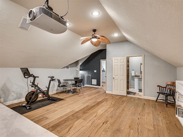 4216 Two Lakes Ave, Norman, OK 73072 - exercise room featuring a textured ceiling, lofted ceiling, wood finished floors, a ceiling fan, and radiator heating unit