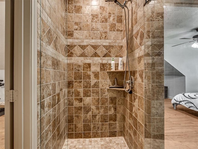 4216 Two Lakes Ave, Norman, OK 73072 - ensuite bathroom with tiled shower, a ceiling fan, and wood finished floors