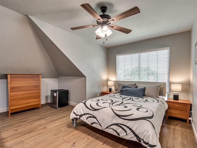 4216 Two Lakes Ave, Norman, OK 73072 - bedroom with hardwood / wood-style floors, ceiling fan, and a textured ceiling