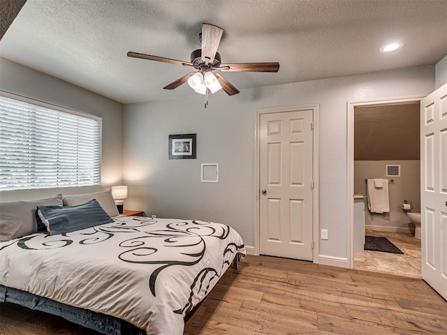 4216 Two Lakes Ave, Norman, OK 73072 - bedroom featuring a textured ceiling, light wood-style floors, recessed lighting, connected bathroom, and ceiling fan