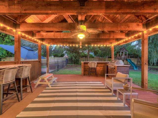 4216 Two Lakes Ave, Norman, OK 73072 - fenced backyard with a gazebo, a wooden deck, and a playground