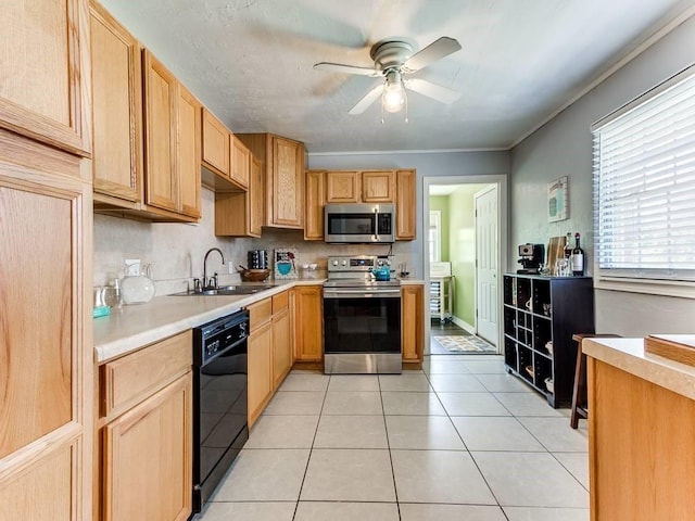 kitchen featuring a healthy amount of sunlight, stainless steel appliances, light countertops, ceiling fan, and a sink