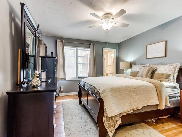 bedroom with baseboards, wood finished floors, and ceiling fan