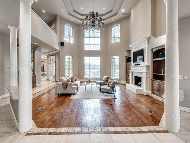 living area featuring recessed lighting, baseboards, a chandelier, and a healthy amount of sunlight