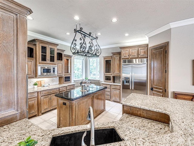 kitchen featuring backsplash, light stone countertops, light tile patterned floors, built in appliances, and recessed lighting