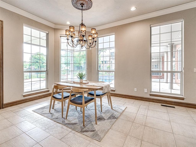 dining space featuring visible vents, ornamental molding, baseboards, and a notable chandelier