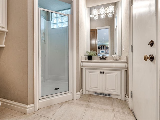 bathroom with baseboards, a stall shower, and tile patterned floors